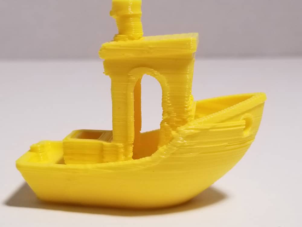 Last yellow "benchi" tugboat from side close up.