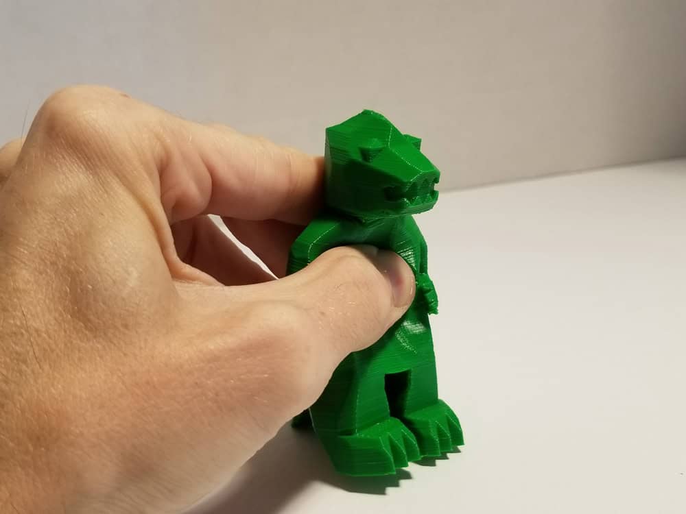 Tevo Michelangelo 3D Printer -- TPU filament -- green Godzilla -- being held.