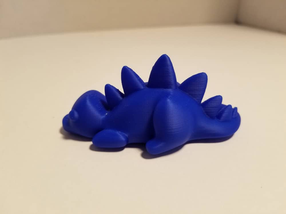 Photo of 3D printout of blue stegosaurus.