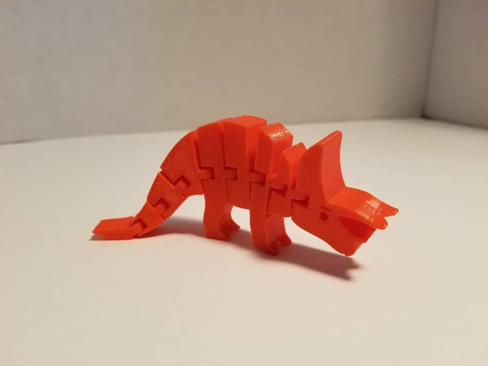 Photo of red triceratops 3D printout.
