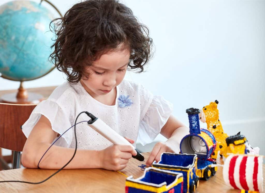 a girl using a 3d pens