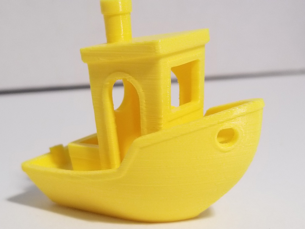 Photo: Yellow "benchi" tugboat with printer issues fixed. Side view.