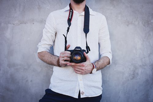 man holding digital camera